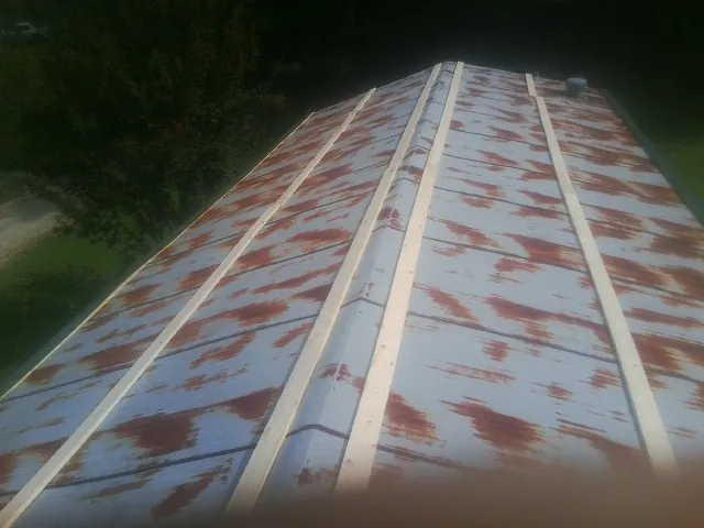 Rusted metal roof panels with new wood purlins before replacement — Storm Damage Roof Repair in Iona by Roofing Brothers